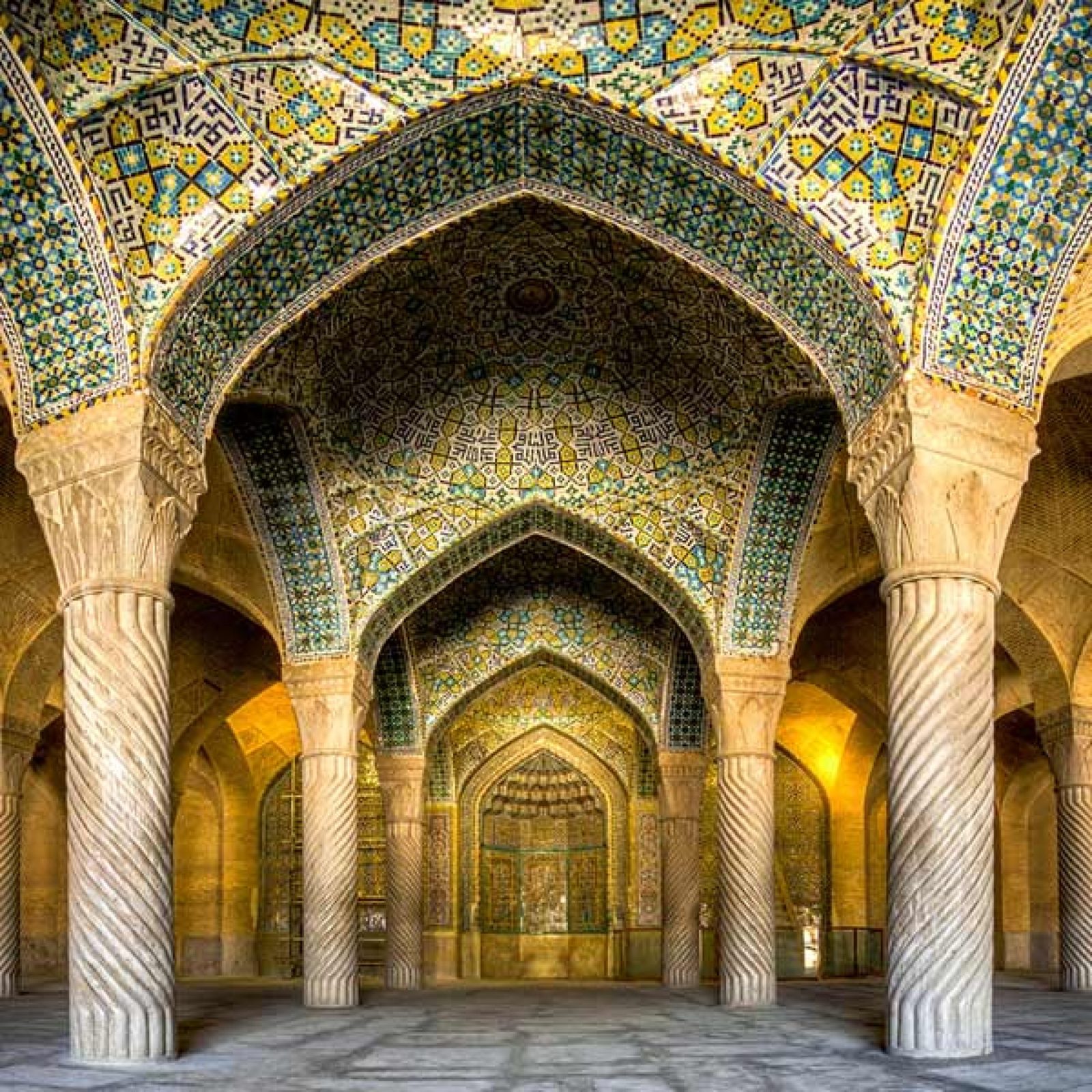 Rows of spiralled stone columns in the columned prayer hall of the Vakil Mosque in Shiraz